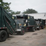 Garbage trucks from sanitary district No. 2 line up across the street from the Baldwin Fire Dept. (below)