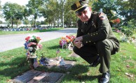 Saving Grace: Lifelong Wantagh resident and AMT Children of Hope/Baby Safe Haven President Timothy Jaccard kneels before the graves of several newborns he buried at Holy Rood Cemetery's Island of Hope in Westbury. The children were discovered abandoned, the victims of homicide. (Ethan Stokes/Long Island Press)