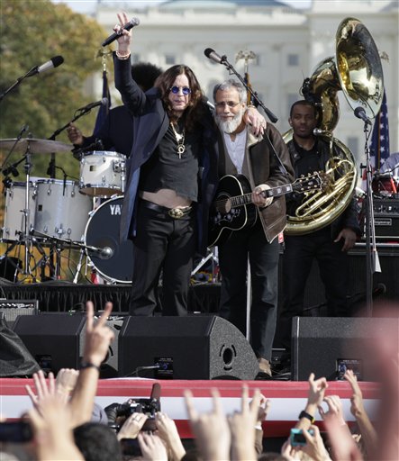 Rocker Ozzy Osbourne and folk artist Yusuf (formerly Cat Stevens) wave to the crowd during  the Rally to Restore Sanity and/or Fear on the National Mall in Washington, Saturday, Oct. 30, 2010. (AP Photo/Carolyn Kaster)