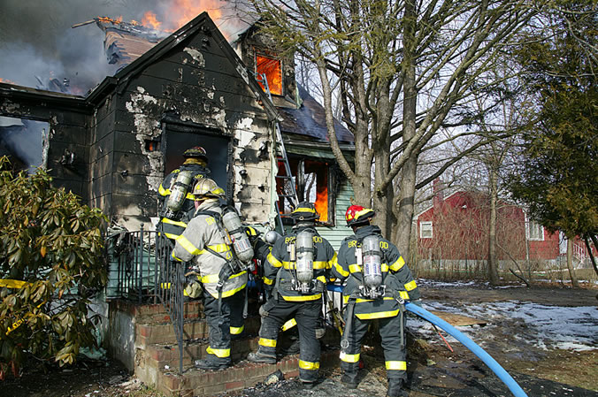 Gordon Heights Fire Department firefights battle a blaze in 2009. Brookhaven township officials are reviewing a study that details how to best mitigate the fact that Gordon Heights residents pay the highest fire district taxes on Long Island (courtesy of Gordon Heights Fire Department)