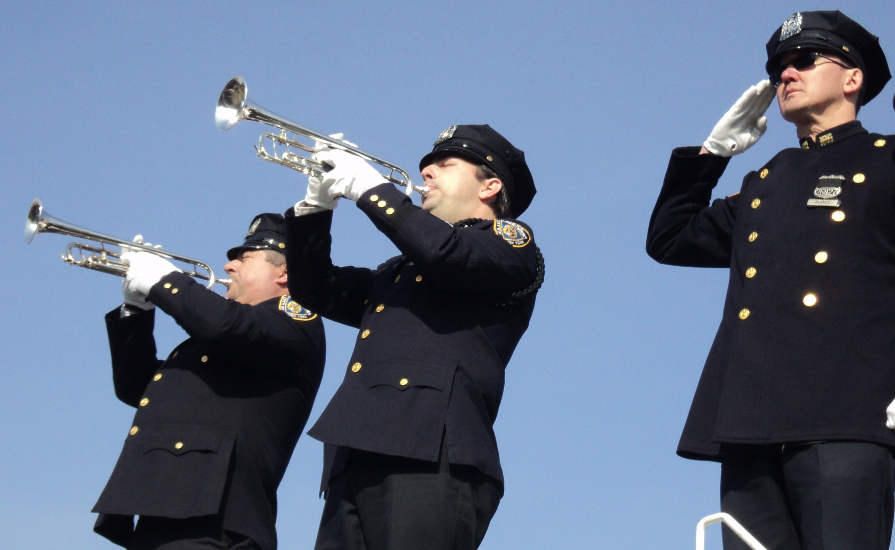 NYPD officers play Taps for fallen New York City Police Officer Alain Schaberger in East Islip