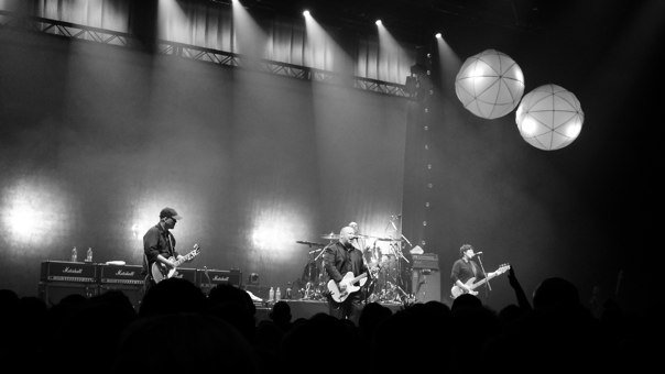 A fan photo of The Pixies playing a concert at an unspecified venue.