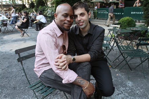 Darren Major, left, and his husband Andrew Troup pose for a photograph Thursday June 30, 2011 in New York.  The couple, who live in New York, were legally wed in Canada in 2008.   As gay marriage becomes legal in New York, companies and individuals are wrestling with changes to their financial lives.   Gay couples who get married can file jointly on state returns but not federal. Big corporations that extend benefits to domestic partners must decide whether to continue in light of the new state law. That means some couples might have to head to the altar to maintain their benefits. (AP Photo/Tina Fineberg)