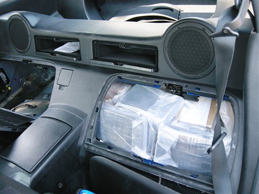 In this undated photo provided by the Suffolk County District Attorneys Office in Hauppauge, N.Y., a secret compartment in a Nissan 350 Z is shown containing a stash of drugs. The car was among those used by a smuggling ring to move cash and cocaine between California and New York, Suffolk County District Attorney Thomas Spota said at a news conference, Wednesday, Aug. 3, 2011. (AP Photo/Suffolk County District Attorneys Office)