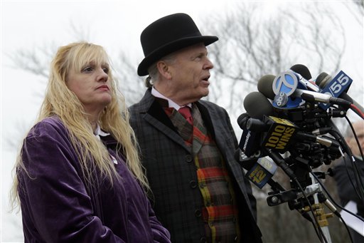 Mari Gilbert, left, looks on as her lawyer John Ray speaks to the media at a news conference in Babylon, N.Y., Tuesday, Dec. 20, 2011. Gilbert, the mother of a prostitute whose remains were found in a Long Island marsh, says she believes her daughter was murdered by a serial killer, and wants federal authorities to take over the investigation.  (AP Photo/Seth Wenig)