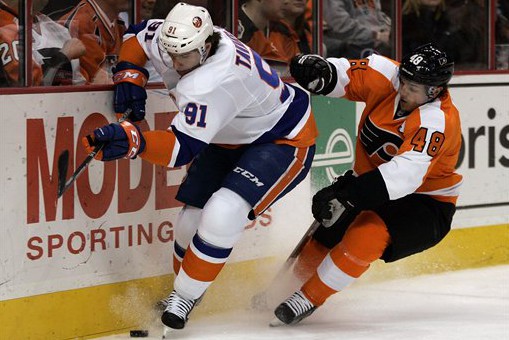 New York Islanders' John Tavares, left, and Philadelphia Flyers' Danny Briere, right, chase the puck during the first period of an NHL hockey game on Thursday,  Jan. 19, 2012, in Philadelphia. (AP Photo/Tom Mihalek)