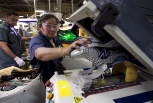 In this Tuesday, May 1, 2012, file photo, worker Maria Contrero, of Boston, removes an elite running shoe from a sole press during the assembly process at the New Balance Athletic Shoe, Inc. factory in Boston. A U.S. economy that plodded along in the first three months of the year likely grew even less in the April-June quarter. And most economists no longer think growth will strengthen much in the second half of 2012. (AP Photo/Steven Senne, File)