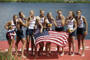 U.S. rowers, including coxswain Mary Whipple, center, Caryn Davies, Caroline Lind, Eleanor Logan, Meghan Musnicki, Taylor Ritzel, Esther Lofgren, Zsuzsanna Francia, and Erin Cafaro celebrate on the podium after winning the gold medal for the women's rowing eight in Eton Dorney, near Windsor, England, at the 2012 Summer Olympics, Thursday, Aug. 2, 2012. (AP Photo/Natacha Pisarenko)