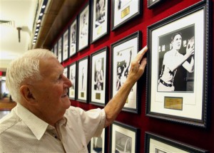 This Sept. 2, 2011 file photo shows Ray Lumpp, basketball gold medalist for the U.S. at the 1948 Olympics in London, pointing out his photo among those reserved for Olympic champions, at the New York Athletic Club. When the U.S. men's basketball team play Argentina on Friday night, the 89-year-old Lumpp promises to cheer louder than anyone else. (AP Photo/Bebeto Matthews, File)