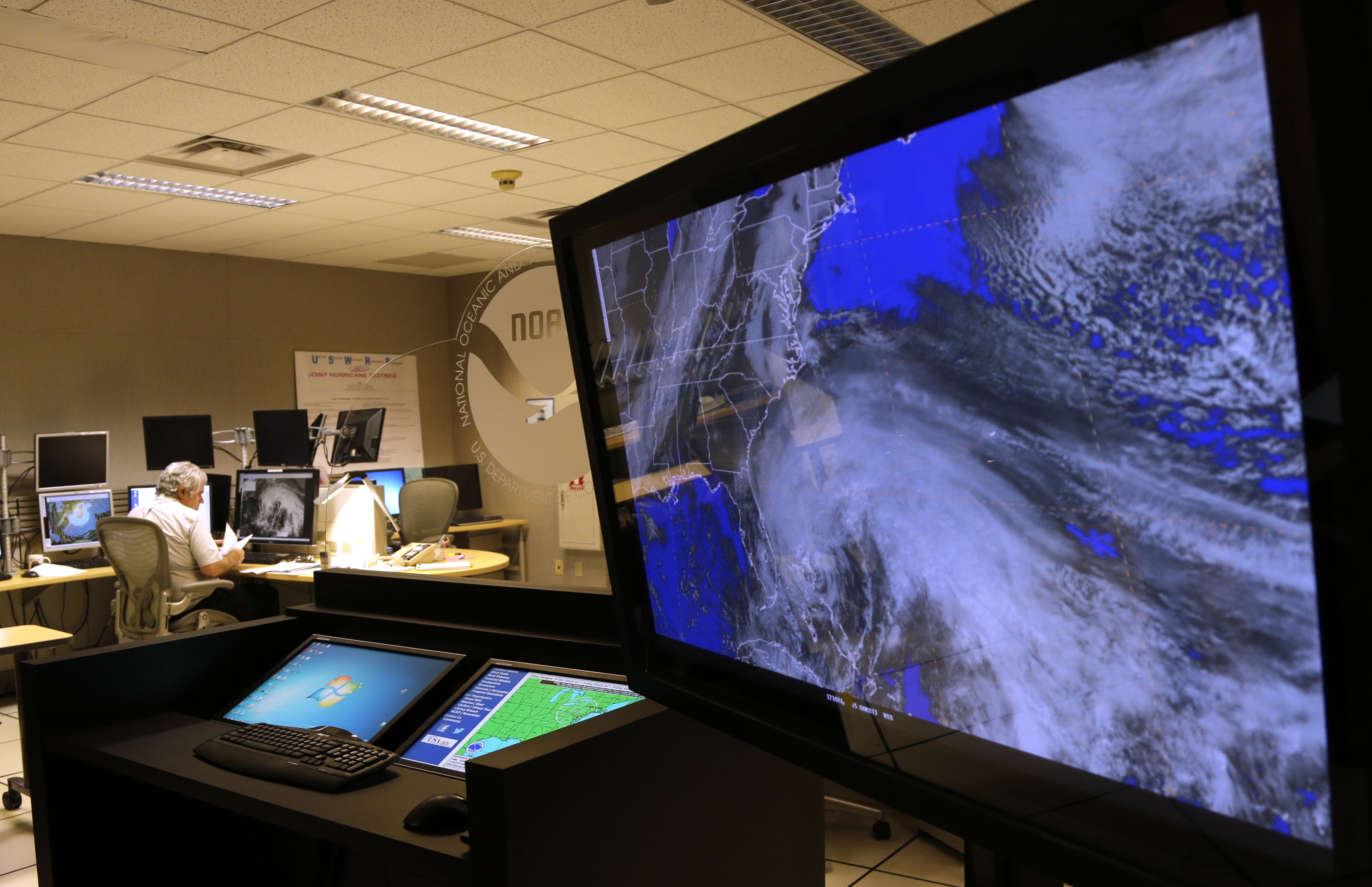 A satellite image of Hurricane Sandy is shown on a computer screen at the National Hurricane Center in Miami on Friday, Oct. 26, 2012. Sandy left 21 people dead as it moved through the Caribbean, following a path that could see it blend with a winter storm and reach the U.S. East Coast as a super-storm next week. (AP Photo/Lynne Sladky)
