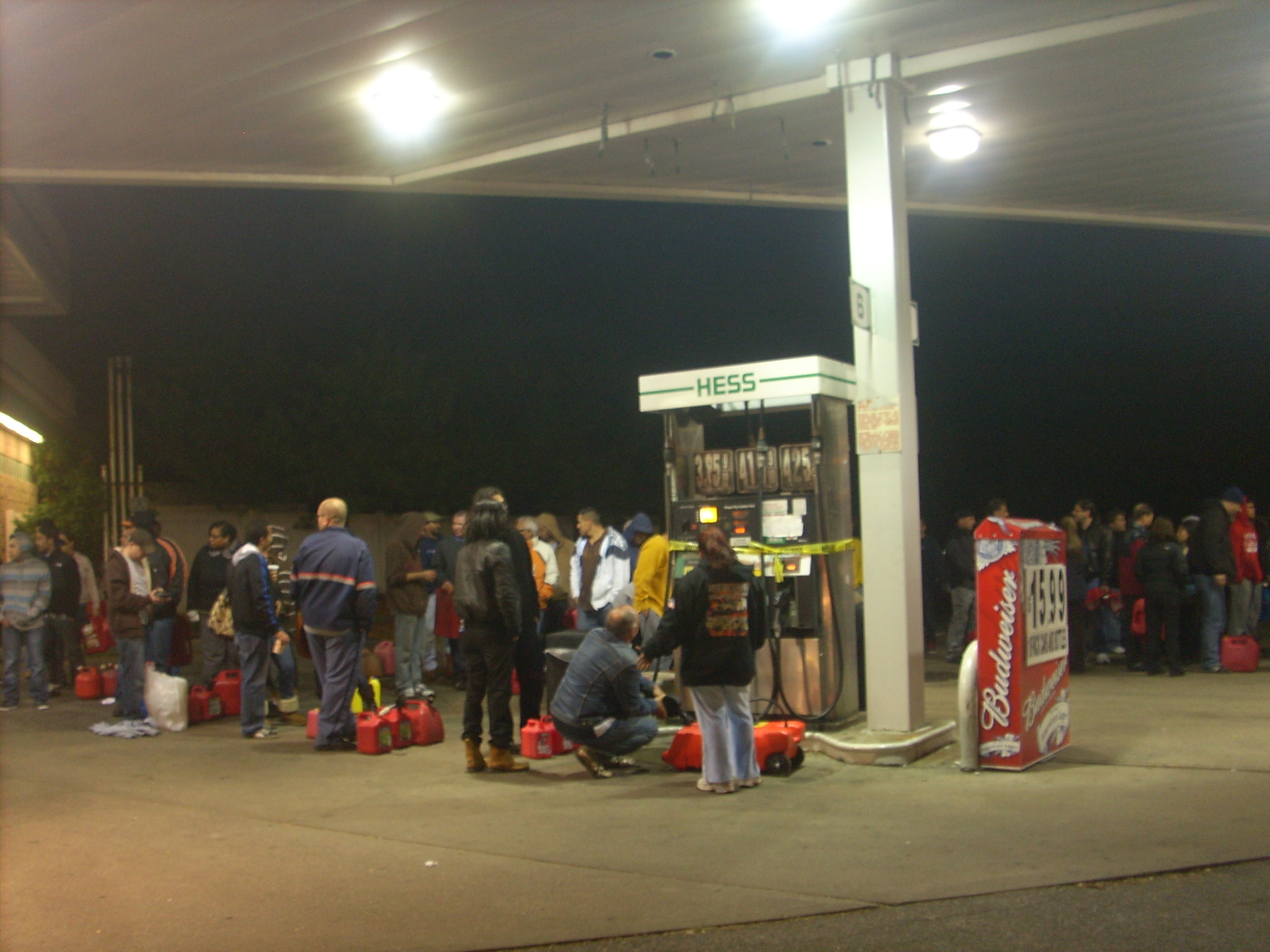 People stood in long lines at a Hess gasoline station on Old Country Road in Hicksville late Thursday, Nov. 1 filling gas cans and containers for vehicles and generators. Much of Long Island remained without power nearly a week after Hurricane Sandy wreaked havoc across the Northeast. (Christopher Twarowski/Long Island Press)