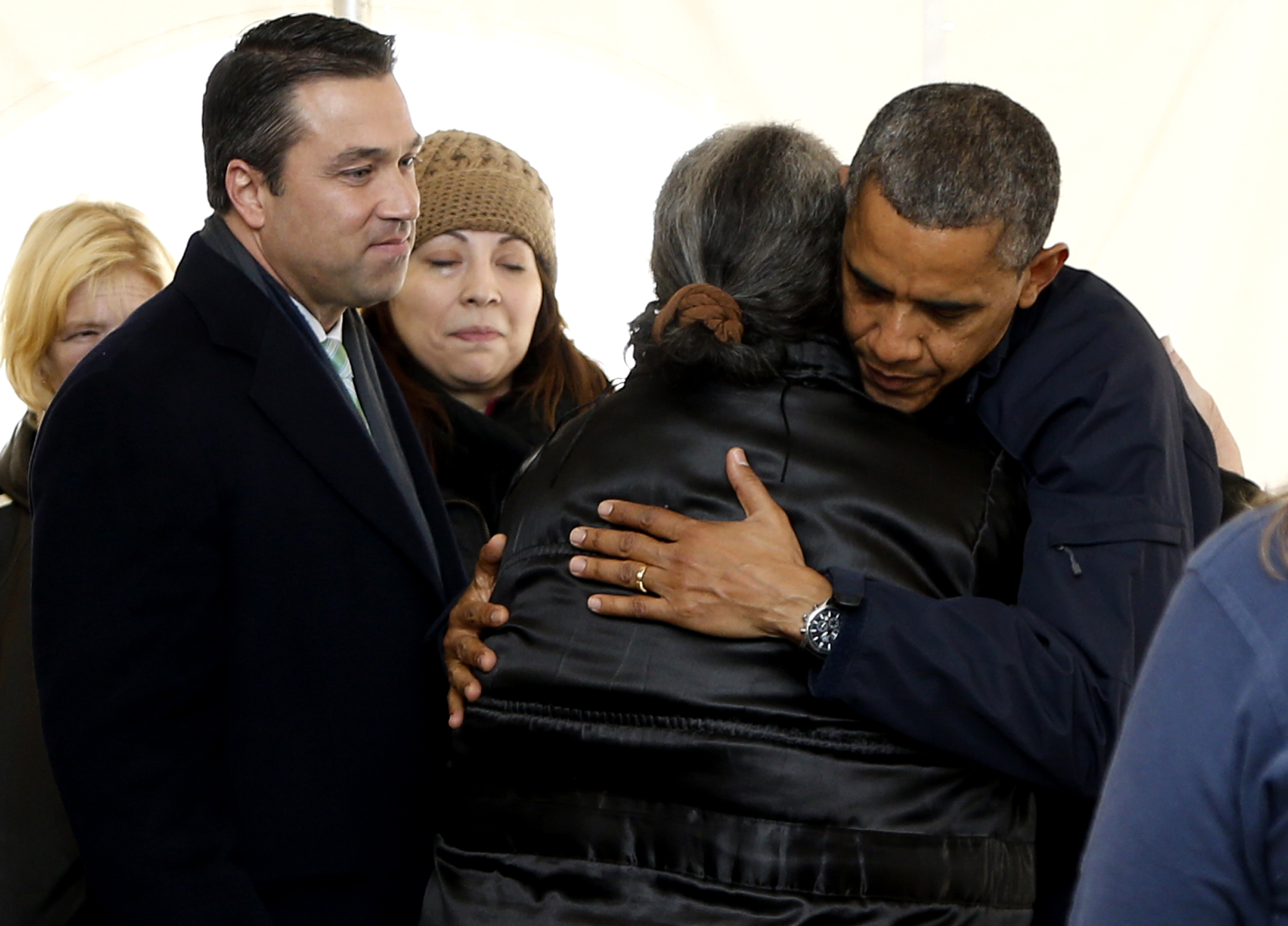 President Barack Obama hugs a woman as he visits the FEMA recovery center on the grounds of New Dorp High School, Thursday, Nov. 15, 2012  on Staten Island, in New York. At left is Rep. Michael Grimm, R-N.Y. (AP Photo/Carolyn Kaster)