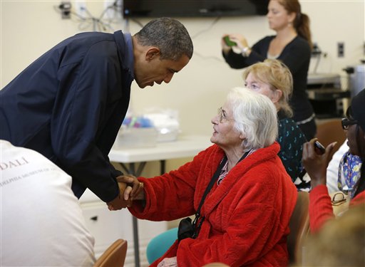 President Barack Obama meets with a local resident at the Brigantine Beach Community Center in Brigantine, NJ., Wednesday, Oct. 31, 2012. Obama traveled to Atlantic Coast to see first-hand the relief efforts after Superstorm Sandy damage the Atlantic Coast. (AP Photo/Pablo Martinez Monsivais)