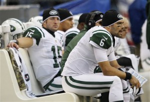 New York Jets quarterback Mark Sanchez (6) sits on the bench near backup quarterback Tim Tebow, left, late in the second half of an NFL football game against the Seattle Seahawks, Sunday, Nov. 11, 2012, in Seattle. The Seahawks won 28-7. Sanchez finished 9 of 22 for 124 yards. Tebow ran four times for 14 yards, and was 3 of 3 passing for 8 yards. (AP Photo/Elaine Thompson)
