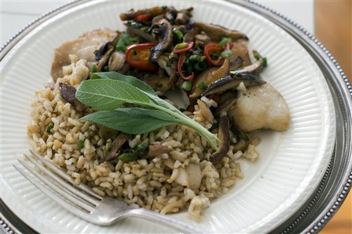 In this image taken on Dec. 3, 2012, Chinese-styled steamed tilapia is shown served on a plate in Concord, N.H. (AP Photo/Matthew Mead)