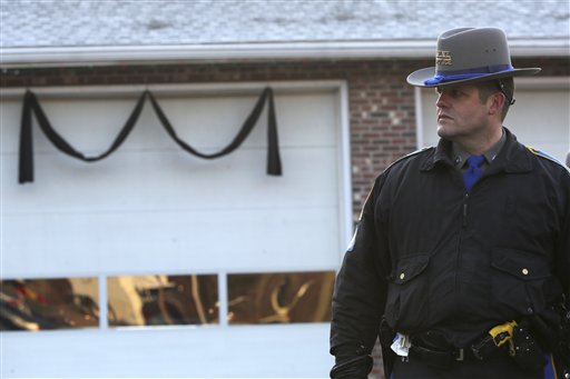 Bunting hangs on the Sandy Hook fire house as a Connecticut State Trooper stands guard outside, Saturday, Dec. 15, 2012 in Sandy Hook village of Newtown, Conn.   The massacre of 26 children and adults at Sandy Hook Elementary school elicited horror and soul-searching around the world even as it raised more basic questions about why the gunman, 20-year-old Adam Lanza, would have been driven to such a crime and how he chose his victims.  (AP Photo/Mary Altaffer)