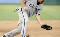 In this July 28, 2012, file photo, Chicago White Sox third baseman Kevin Youkilis (20) makes a play on the ball during a baseball game against the Texas Rangers in Arlington, Texas. A person familiar with the negotiations told The Associated Press Tuesday, Dec. 11, that free agent Youkilis and the New York Yankees have reached agreement on a $12 million, one-year deal. (AP Photo/Matt Strasen, File)