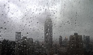 As rain covers a window with droplets, fog partially hides the Empire State building, center, in New York, Tuesday, Sept. 28, 2010. (AP Photo/Bebeto Matthews)