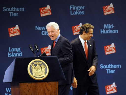 Former President Bill Clinton walks to the podium after New York Gov. Andrew Cuomo introduces him during a New York Open for Business Statewide Conference at the Empire State Plaza Convention Center in Albany, N.Y., Tuesday, Sept. 27, 2011. A $4.4 billion high-tech project involving five global companies will create or retain 6,900 jobs statewide, Cuomo announced Tuesday. (AP Photo/Hans Pennink)