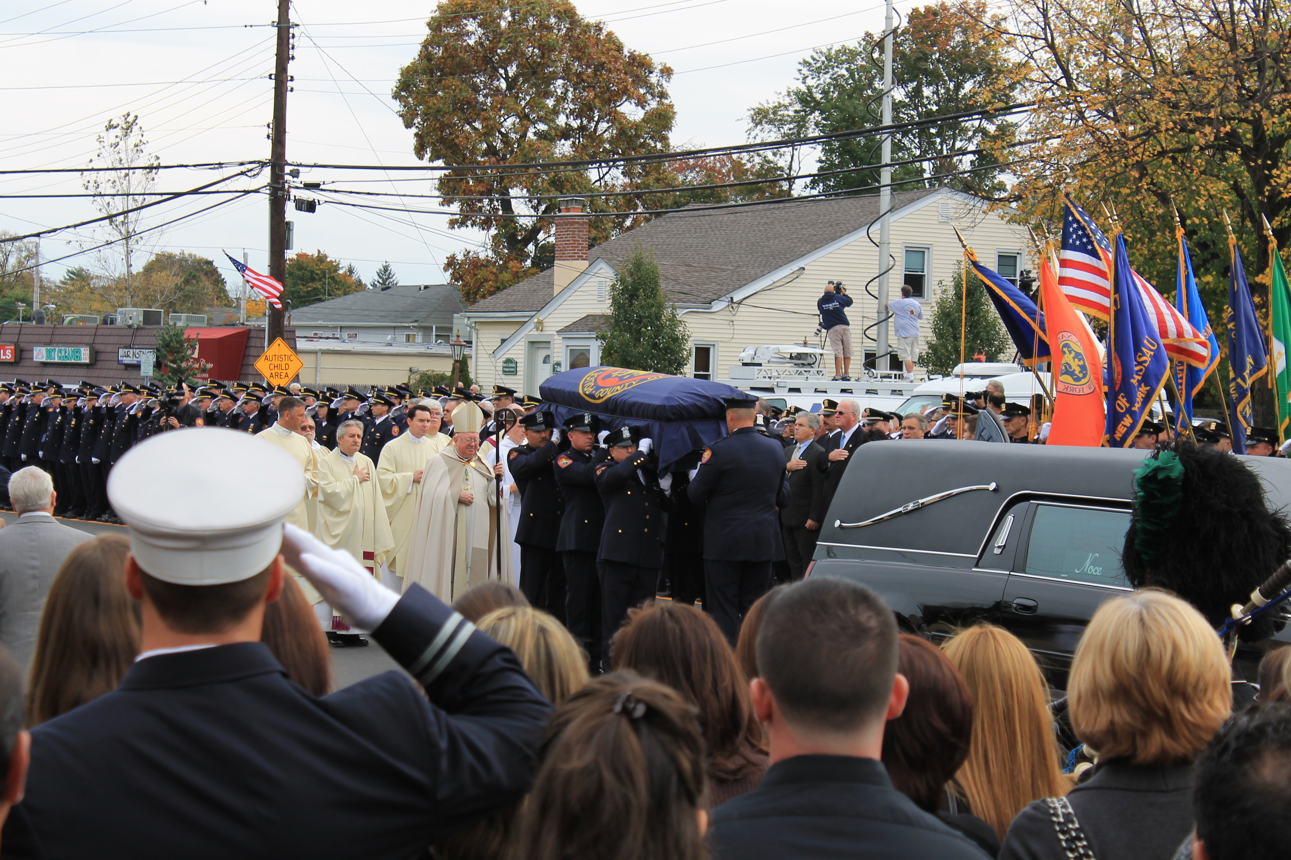 Sea of Blue: Hundreds of Nassau County police officers joined law enforcement agencies from across the region Saturday outside St. Christopher's Church in Baldwin to pay respects to Nassau Police Officer Arthur Lopez, who was gunned down Tuesday in Bellerose Terrace after making a routine traffic stop. (Rashed Mian/Long Island Press)