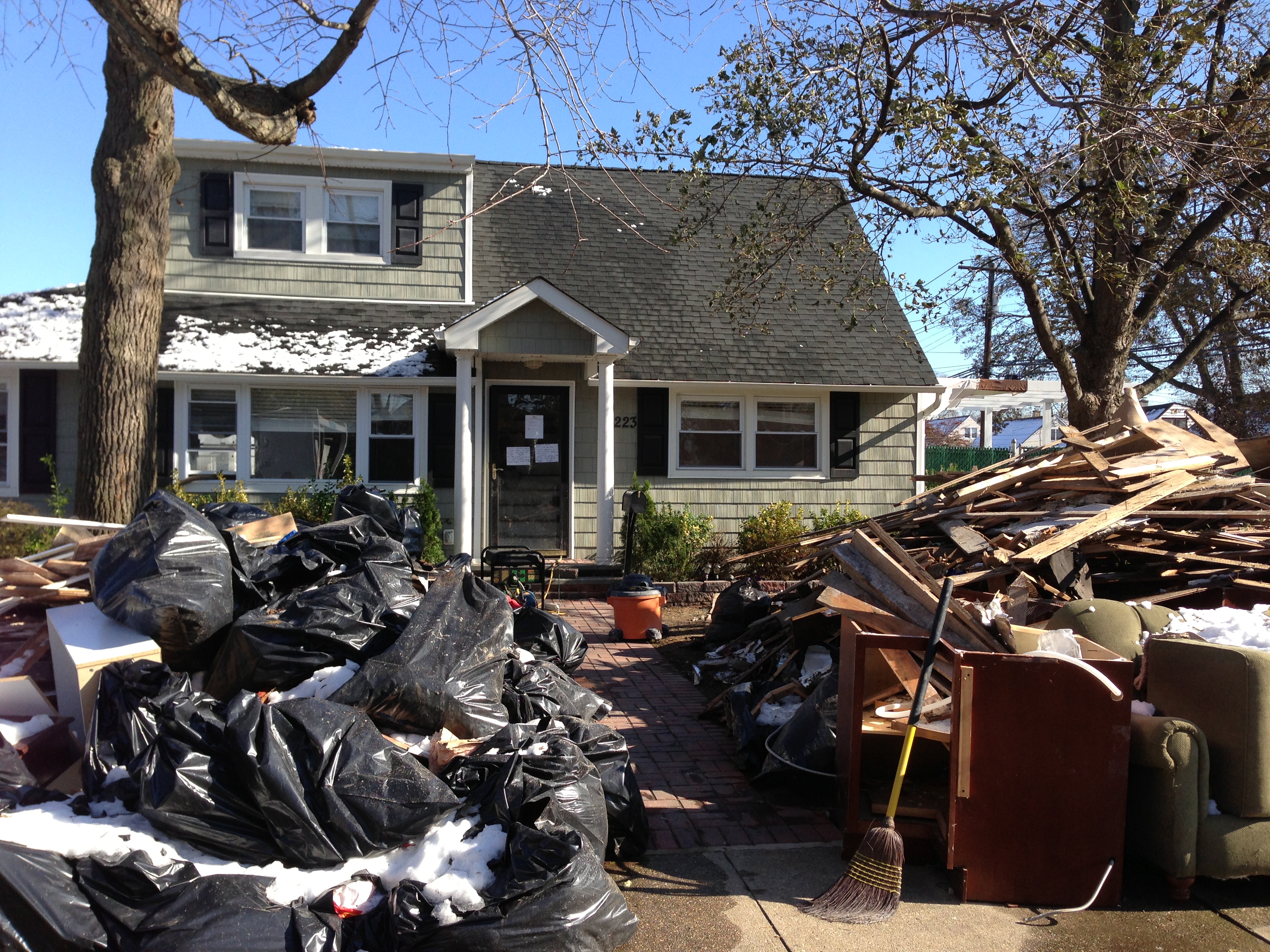 Large piles of water-logged furniture and debris clutter the streets of Oceanside, where residents held a rally Nov. 9, 2012 demanding answers and accountability from LIPA and elected officials. (Christopher Twarowski/Long Island Press)