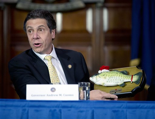 New York Gov. Andrew Cuomo shows off  a Big Mouth Billy Bass to cabinet members that was given to him as a Christmas gift from the Legislative Correspondents' Association on Tuesday, Dec. 18, 2012, in Albany, N.Y. The gift was presented during a gathering on Monday evening at the Executive Mansion. (AP Photo/Mike Groll)