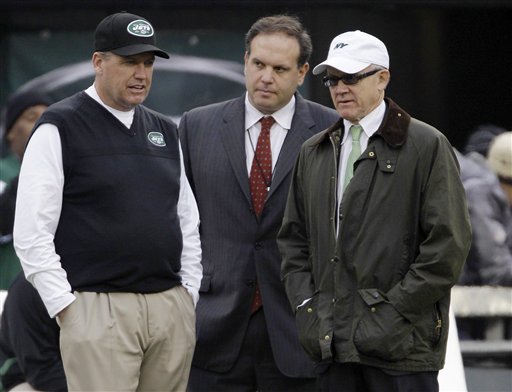In this Dec. 2, 2012, file photo, New York Jets head coach Rex Ryan, left, stands with general manager Mike Tannenbaum, center, and owner Woody Johnson before an NFL football game against the Arizona Cardinals in East Rutherford, N.J. Ryan insists he's a Jet all the way and wants to coach the team for the "next 15 years." He dismisses as "untrue" a report that says he would welcome being fired if Johnson doesn't upgrade the offense. (AP Photo/Kathy Willens, File)