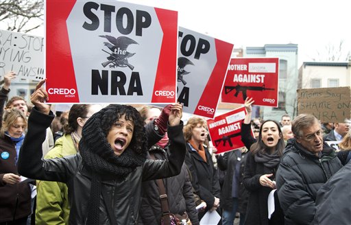 Tasha Devoe, left, of Lawrence, Mass., joins a march to the National Rifle Association headquarters on Capitol Hill in Washington Monday, Dec. 17, 2012.  Curbing gun violence will be a top priority of President Barack Obama's second term, aides say. but exactly what he'll pursue and how quickly are still evolving.   (AP Photo/Manuel Balce Ceneta)