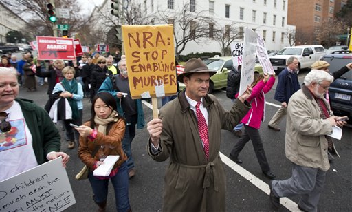 Patrick Hand, center, joins a march to the National Rifle Association headquarters on Capitol Hill in Washington Monday, Dec. 17, 2012.  Curbing gun violence will be a top priority of President Barack Obama's second term, aides say. but exactly what he'll pursue and how quickly are still evolving.  (AP Photo/Manuel Balce Ceneta)